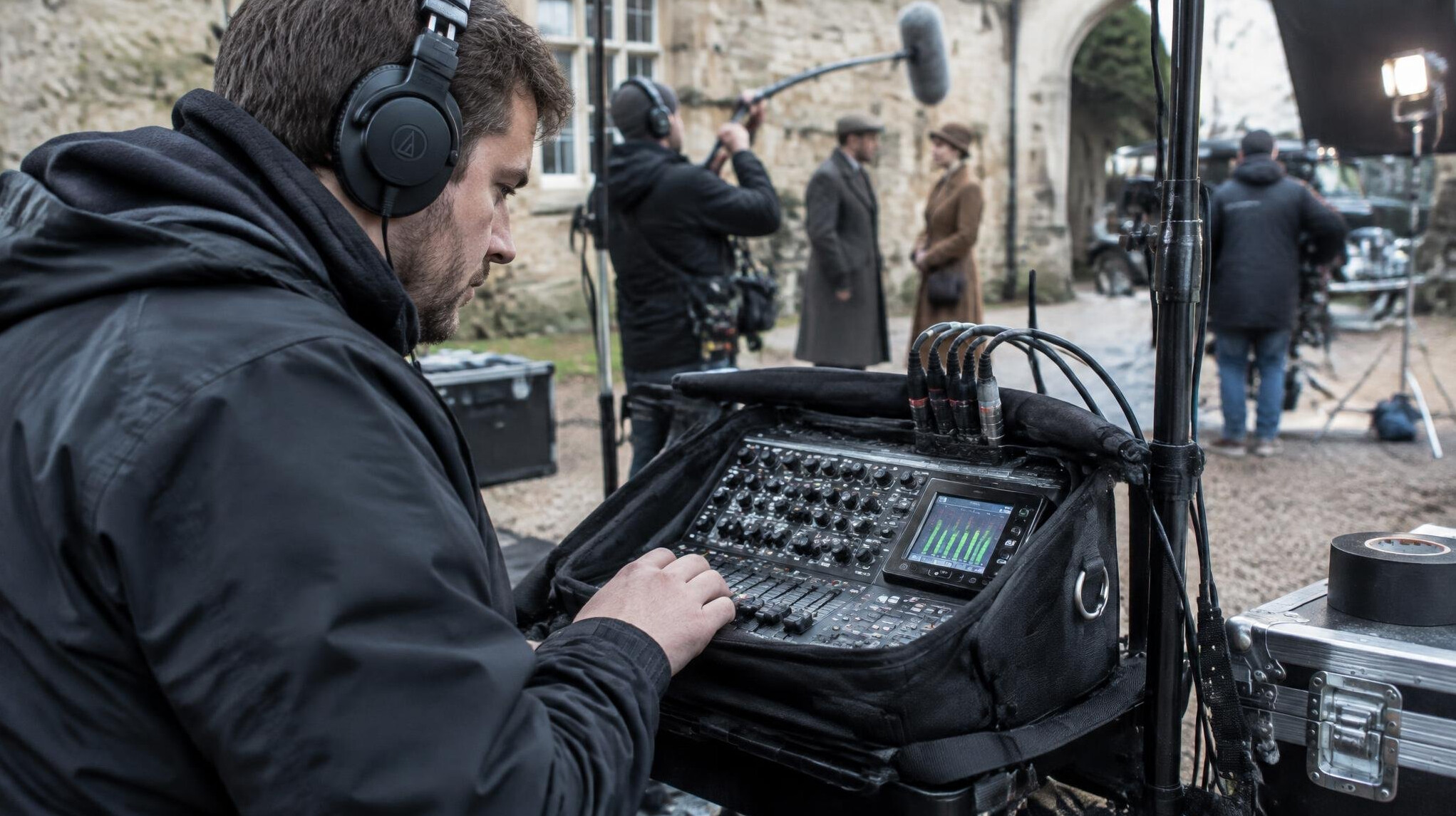 Sound engineer checking microphone levels on a mixing desk