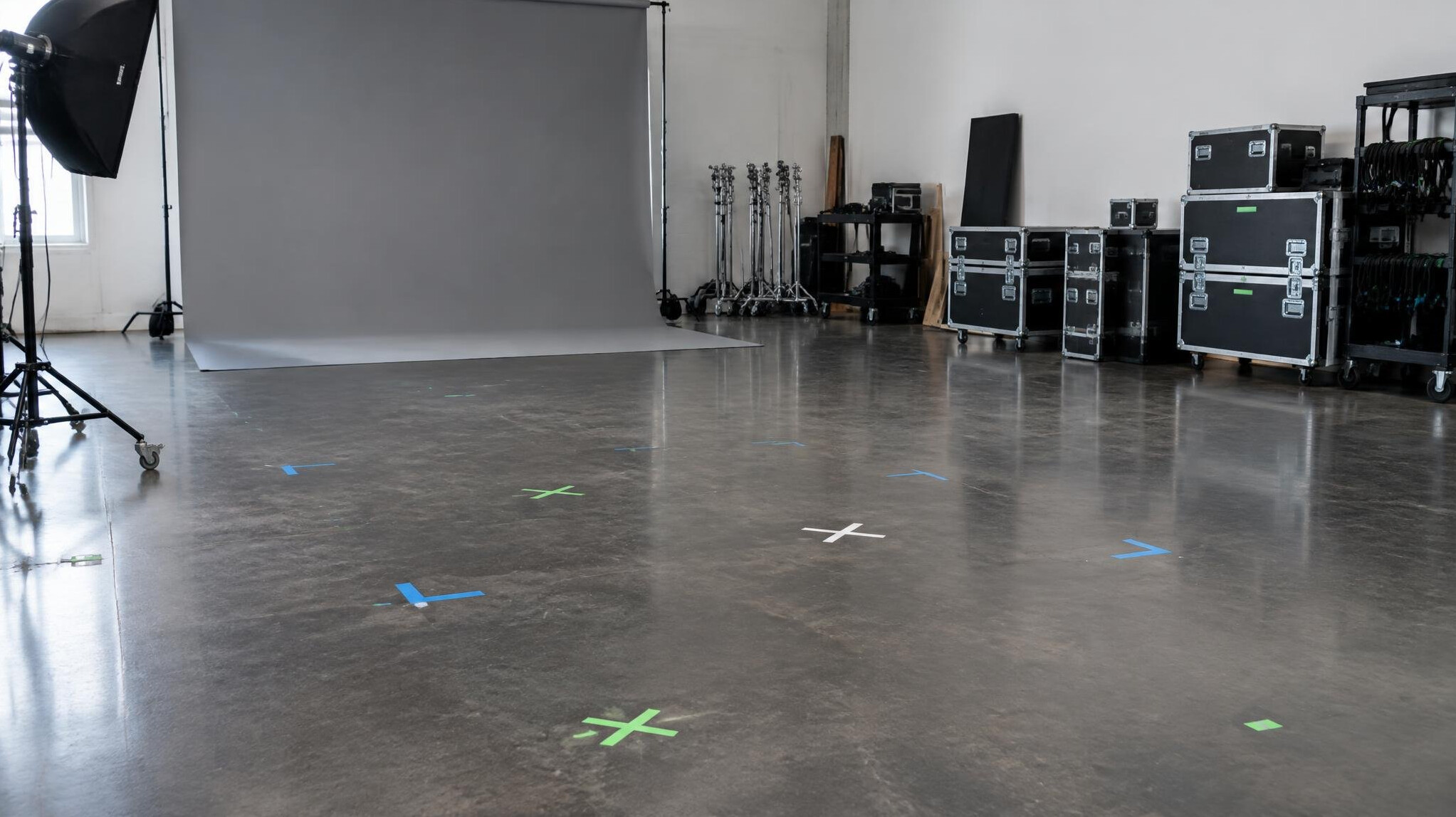 Empty studio floor being prepared with marks and backdrops